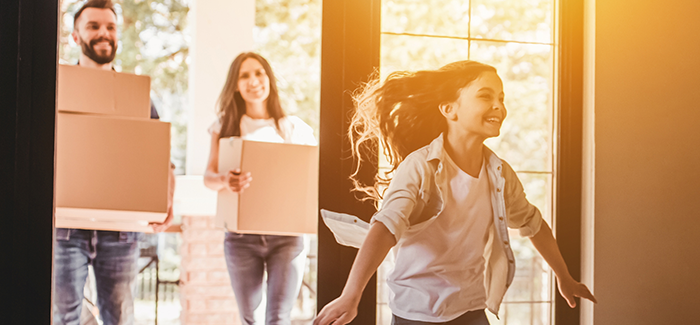 family walking into a new home