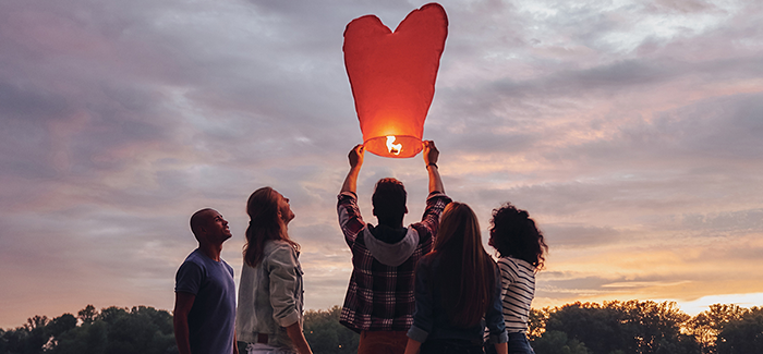 a heart-shaped lantern lifted up to the sky